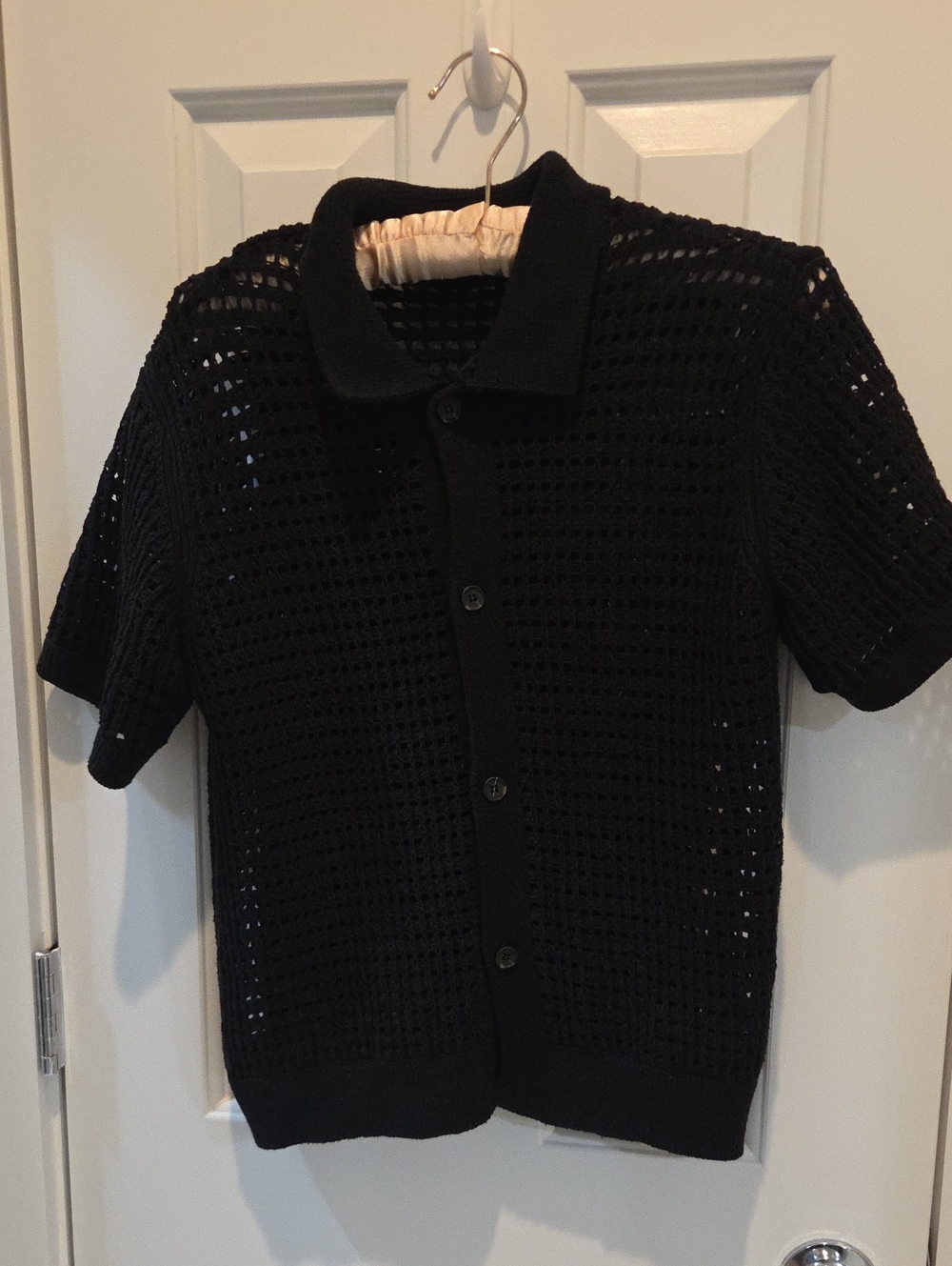 black crochet open-knit button-up polo shirt.